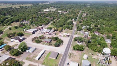 Aerial view of the town of Ladonia, Texas. Camera is flying high above the town and shows the majority of town businesses