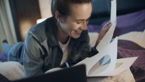 Happy business woman working with papers at home. Business owner finance audit