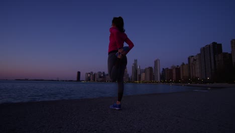 fit hispanic caucasian female silhouette stretching at sunrise
