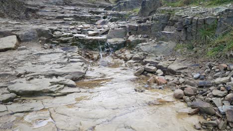 rough broken wet stone pathway cascading rainfall overcast autumn hiking trail