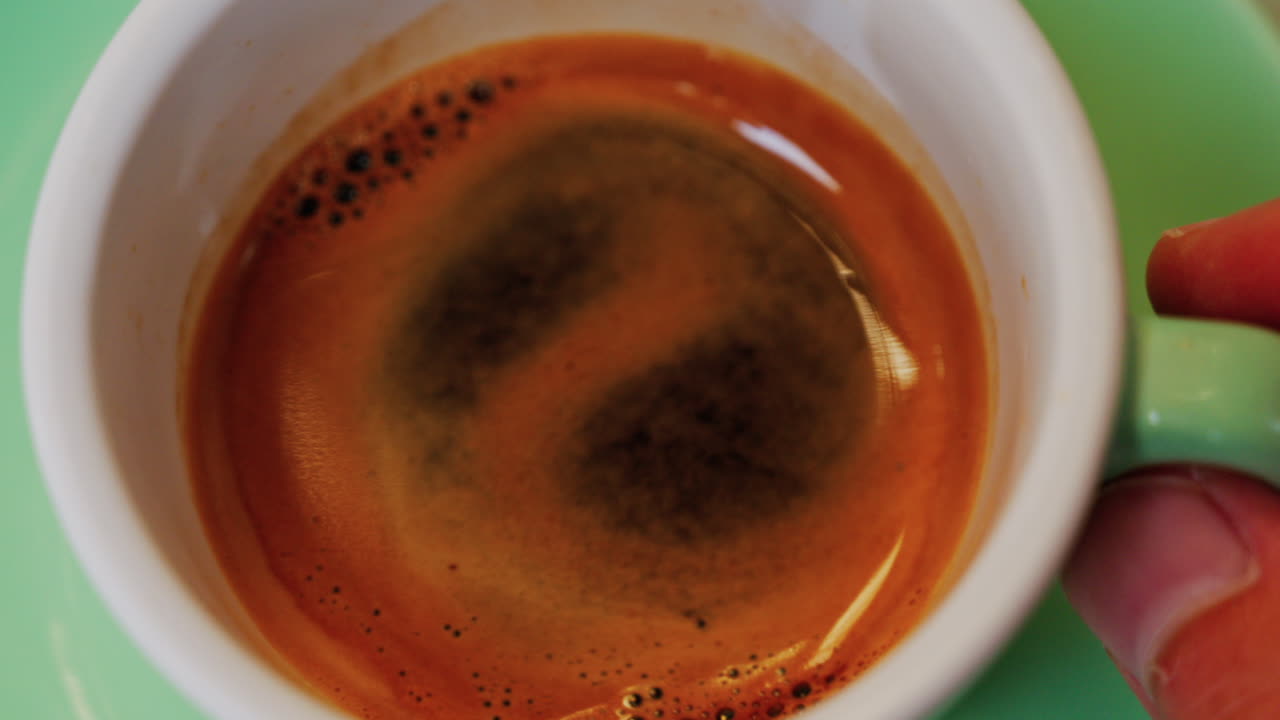 Close up of an espresso cup on a green plate