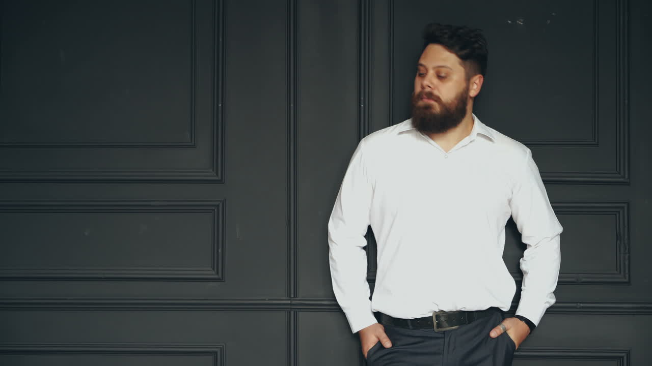 Brutal man in studio. Young casual bearded man posing in studio