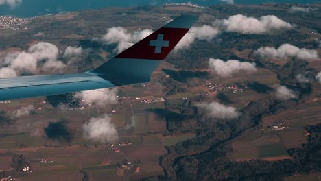 Airplane-window-view,-over-Switzerland