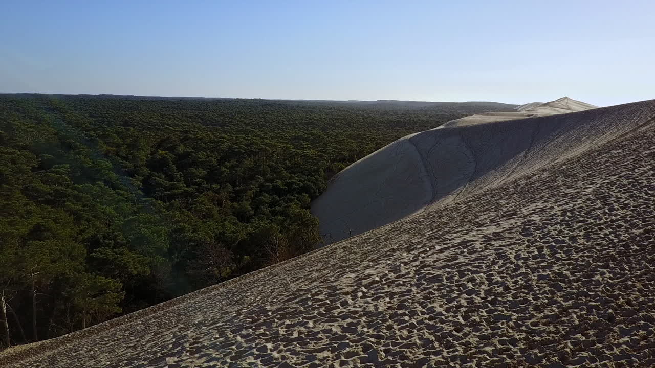 Aerial shot pan left from sea to forest, top of Pyla dune in France