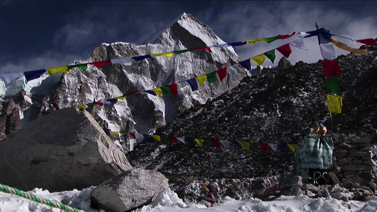 puja alter con banderas de oración y montaña detrás