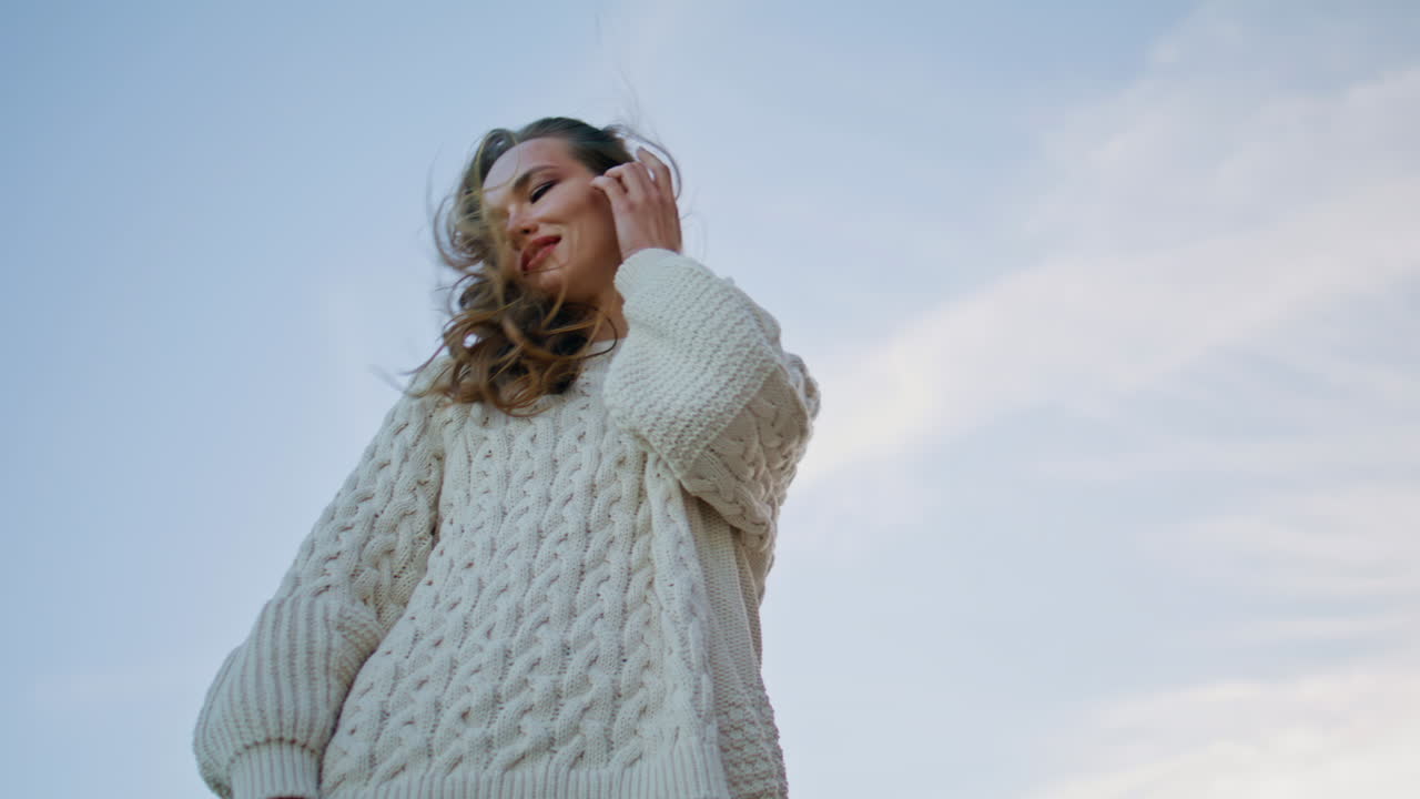 Lady posing blue sky closeup bottom view. Carefree woman smiling under skyline