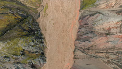 Bird's-eye-view-flying-over-narrow-canyon,-riverbed,-Landmannalaugar,-Iceland