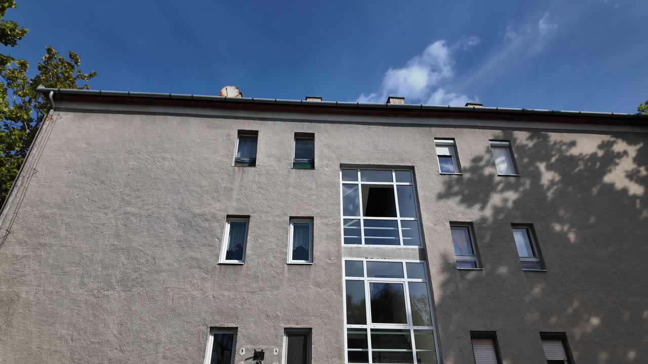 Modern residential building with windows under blue sky