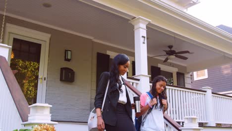 businesswoman mother walking daughter to school on way to work