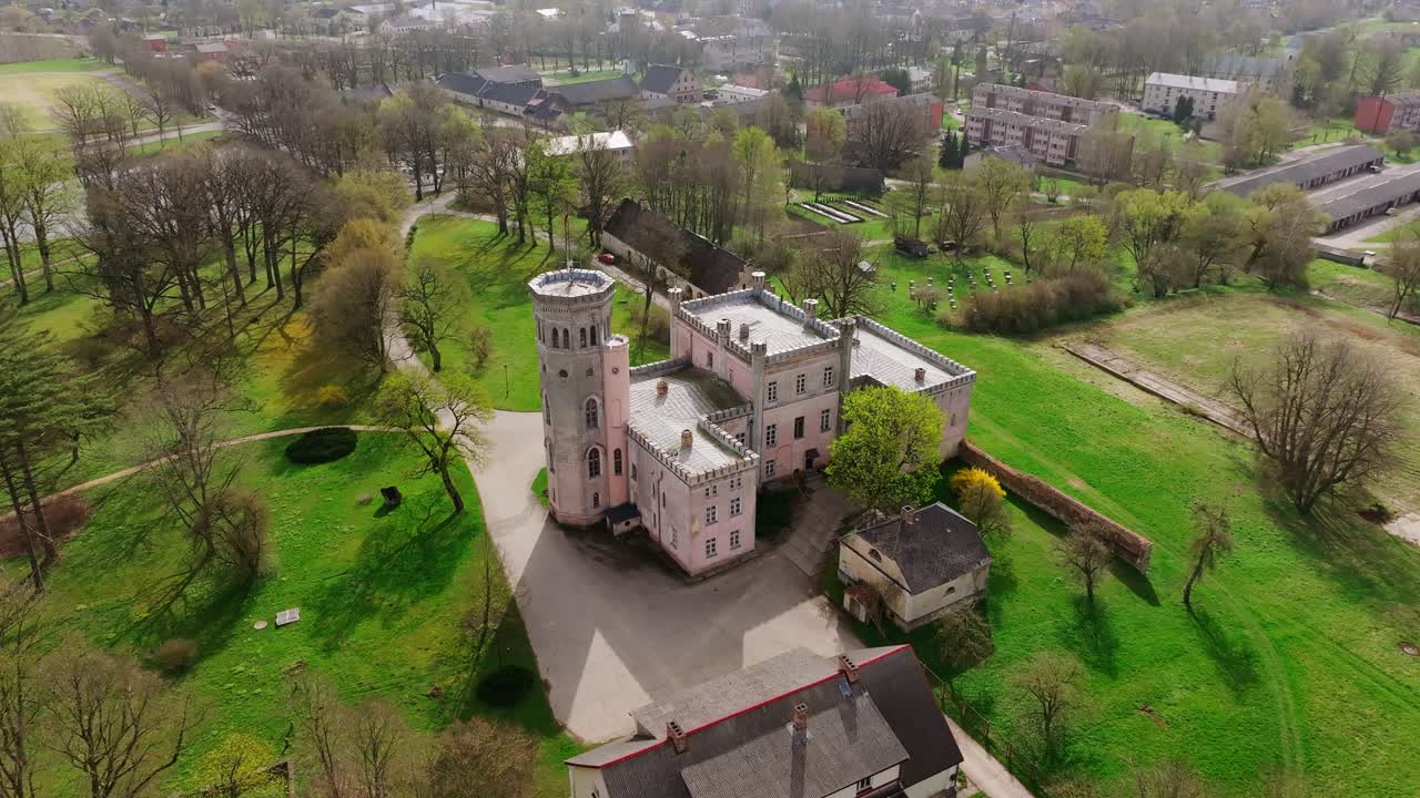 Cinematic drone orbit showing Vecauce Palace, Dobele region during sunny spring