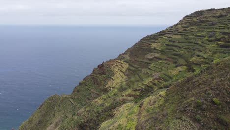 aerial 4k video of steep, terraced hillside overlooking the ocean