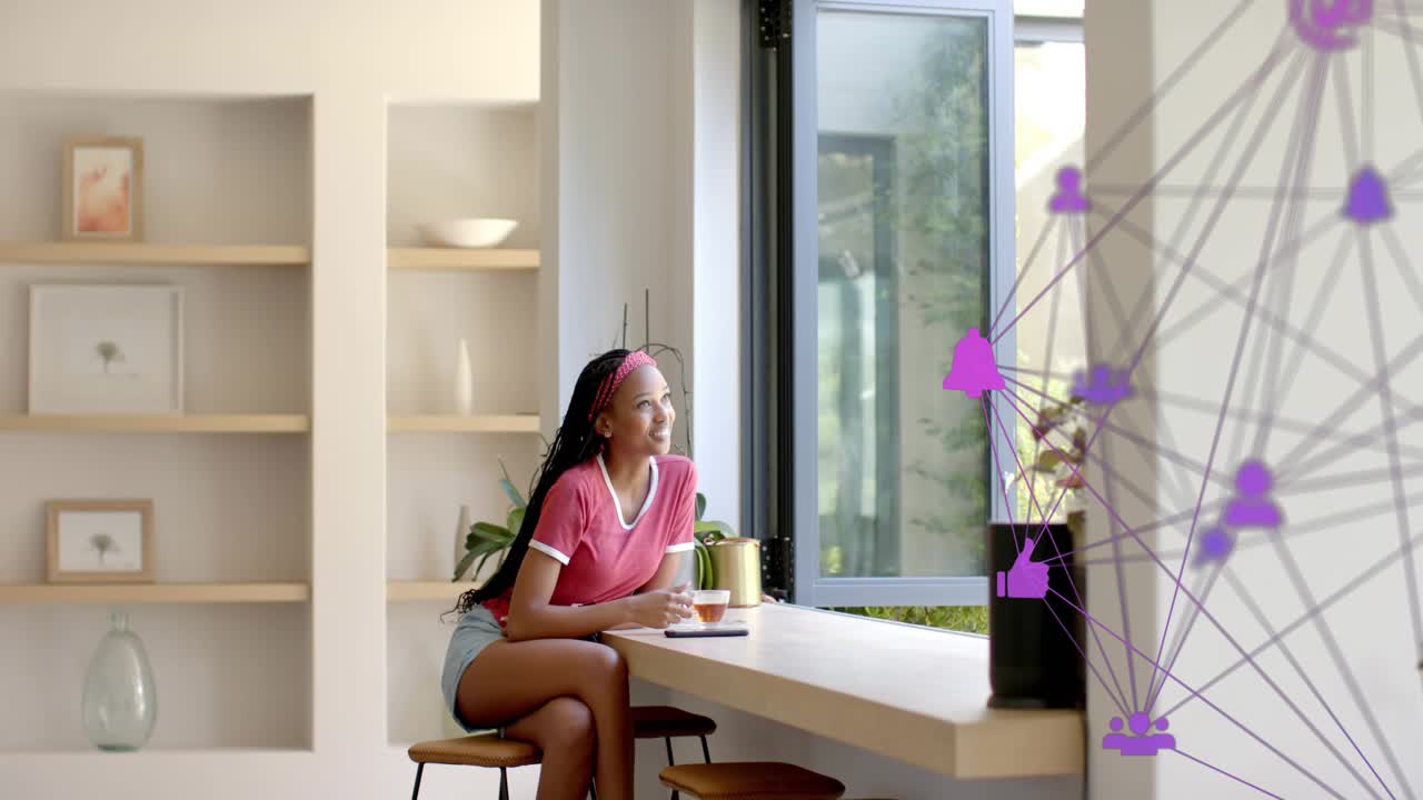 Woman at counter with cup, noticing purple tech network emerging by speaker, leaning, smiling