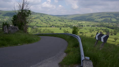 winding road through a green valley with rolling hills