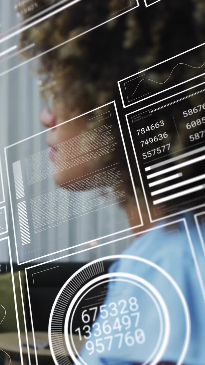 Vertical video: On start woman sitting profile while HUD panels sliding over face showing analytics
