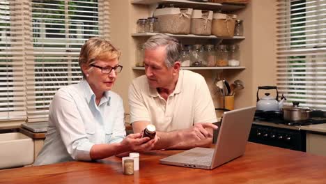 Older-couple-using-laptop-to-look-up-their-medicine