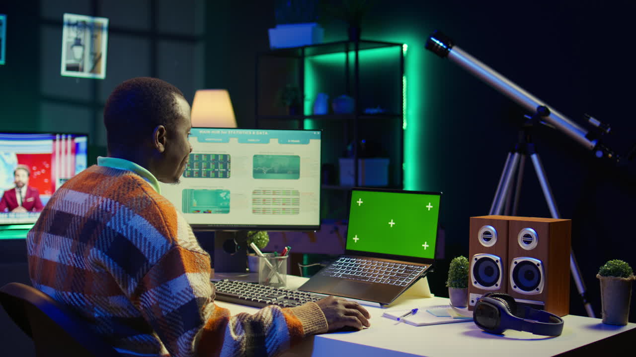 Person working with data on computer with green screen