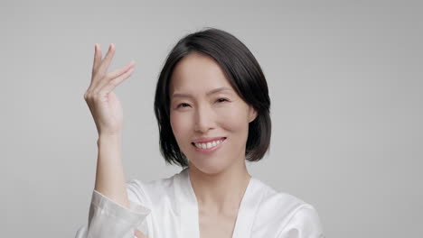 smiling woman in white robe