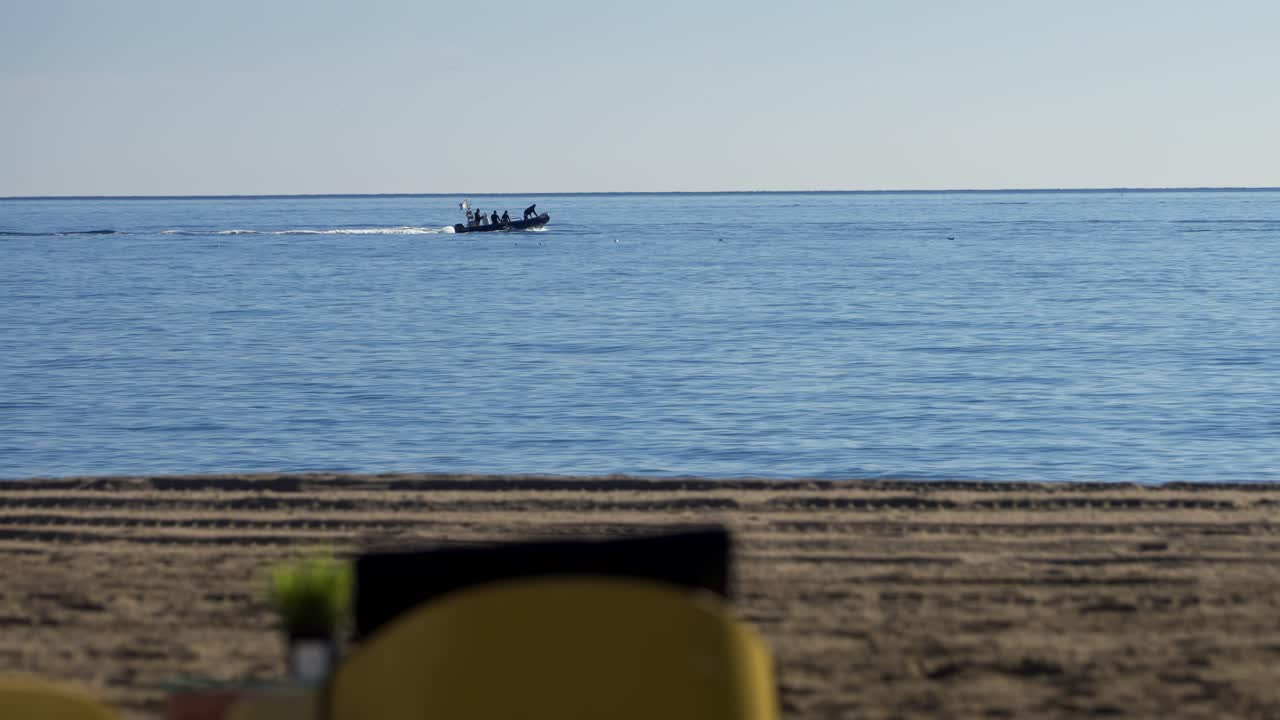Beach in Marbella, with boat passing by on the Mediterranean Sea