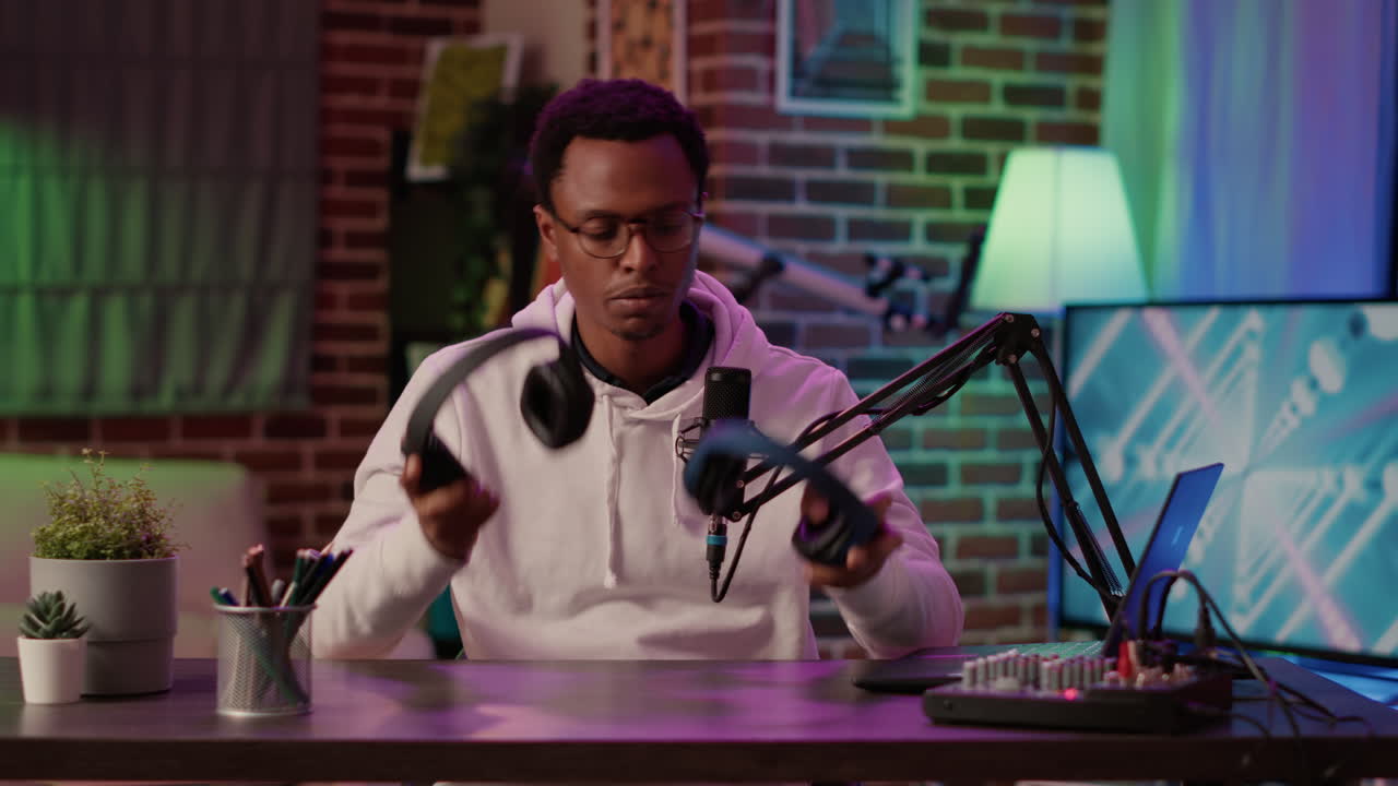 African american content creator recording product review testing headphones using professional audio equipment