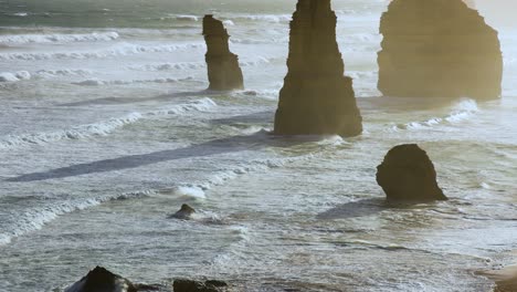 a serene view of the twelve apostles rock formations along the great ocean road, captured at sunrise with gentle waves