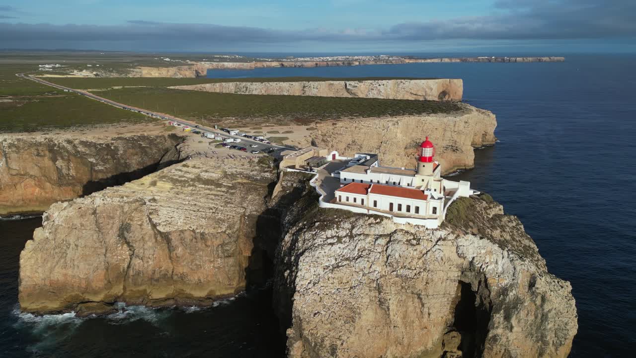 Aerial orbits lighthouse on Cape St Vincent, sea cliffs of Portugal