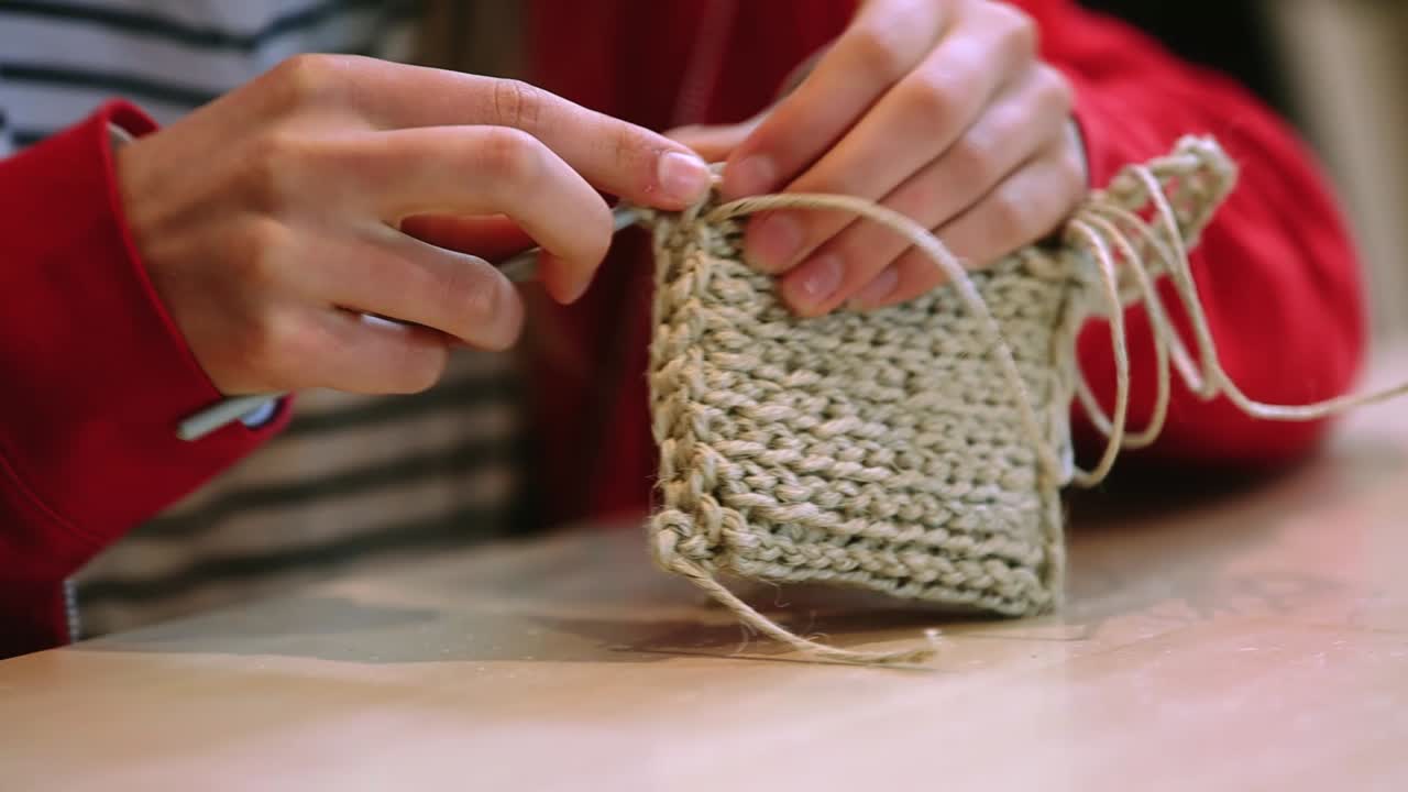 Close-up of a Woman's Hands Crocheting with Jute Yarn