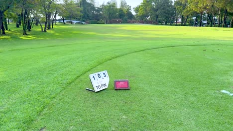 lush green golf course with distance marker