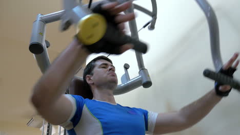 man exercising on chest press machine