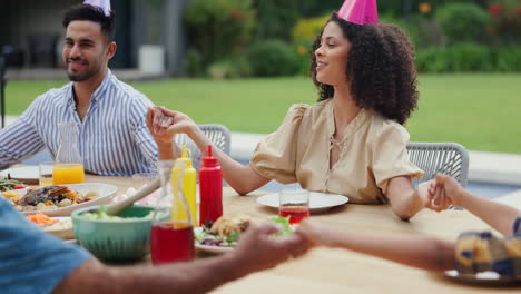 family prayer at a birthday party