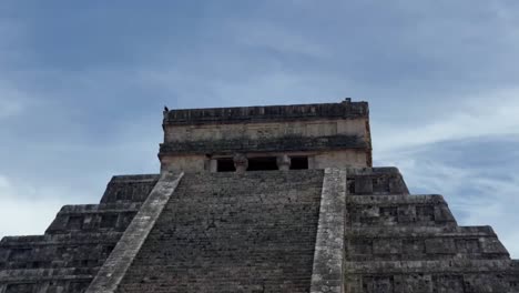 handheld close-up booming down shot of the steep steps at el castillo ancient pyramid in chichen itza, mexico. 4k