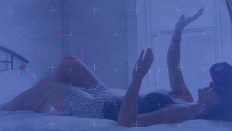 light trails against caucasian woman wearing vr headset gesturing while lying in the bed at home
