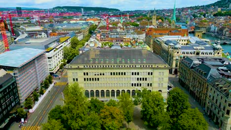 4k drone video of the historic buildings and construction cranes in downtown zurich, switzerland
