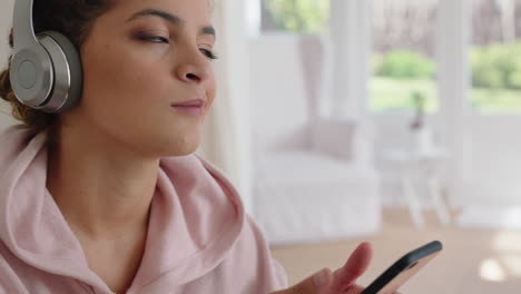 beautiful-teenage-girl-listening-to-music-wearing-headphones-texting-with-smartphone-relaxing-at-home-enjoying-sharing-lifestyle-on-social-media-on-weekend-morning