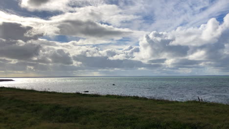 Green-grass-near-the-ocean-on-a-cloudy-day