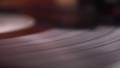 spinning long play vinyl record on vintage gramophone turntable, close up