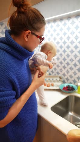 mother and baby in the kitchen preparing breakfast
