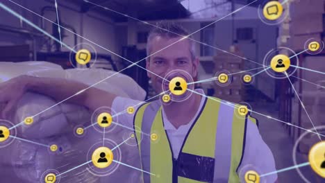 Animation-of-network-of-digital-icons-against-caucasian-male-worker-smiling-at-warehouse