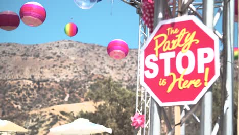 sign saying party stop with festival decoration on background