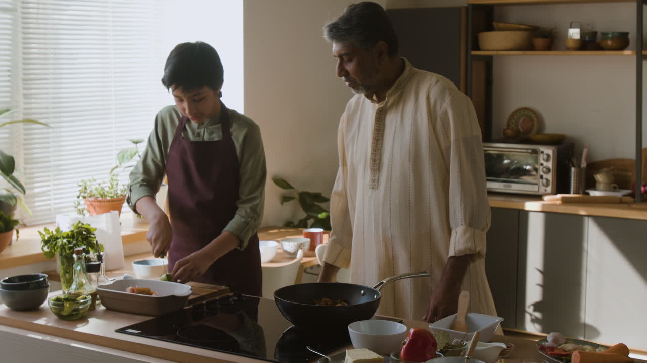 Father and Son Cooking Together in the Kitchen