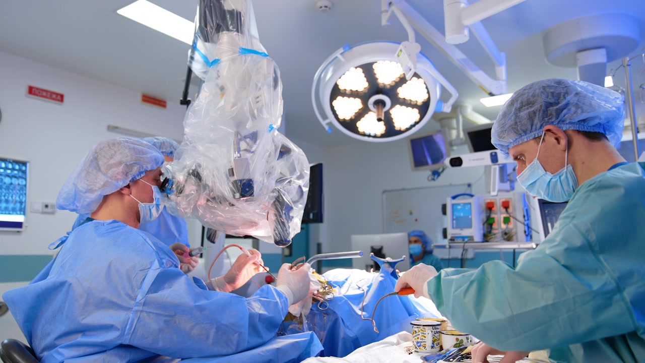 Medical Team Performing Surgery with Surgical Microscope in Operating Room