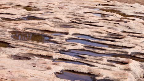 gradual water movement across eroded rock surface