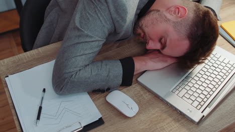 bored tired sleepy business man falling asleep after routine work on laptop computer at office desk