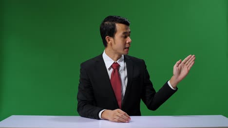 green screen background: live news studio with professional asian male anchor reporting on the events of the day. television channel newsroom concept. chroma key template background