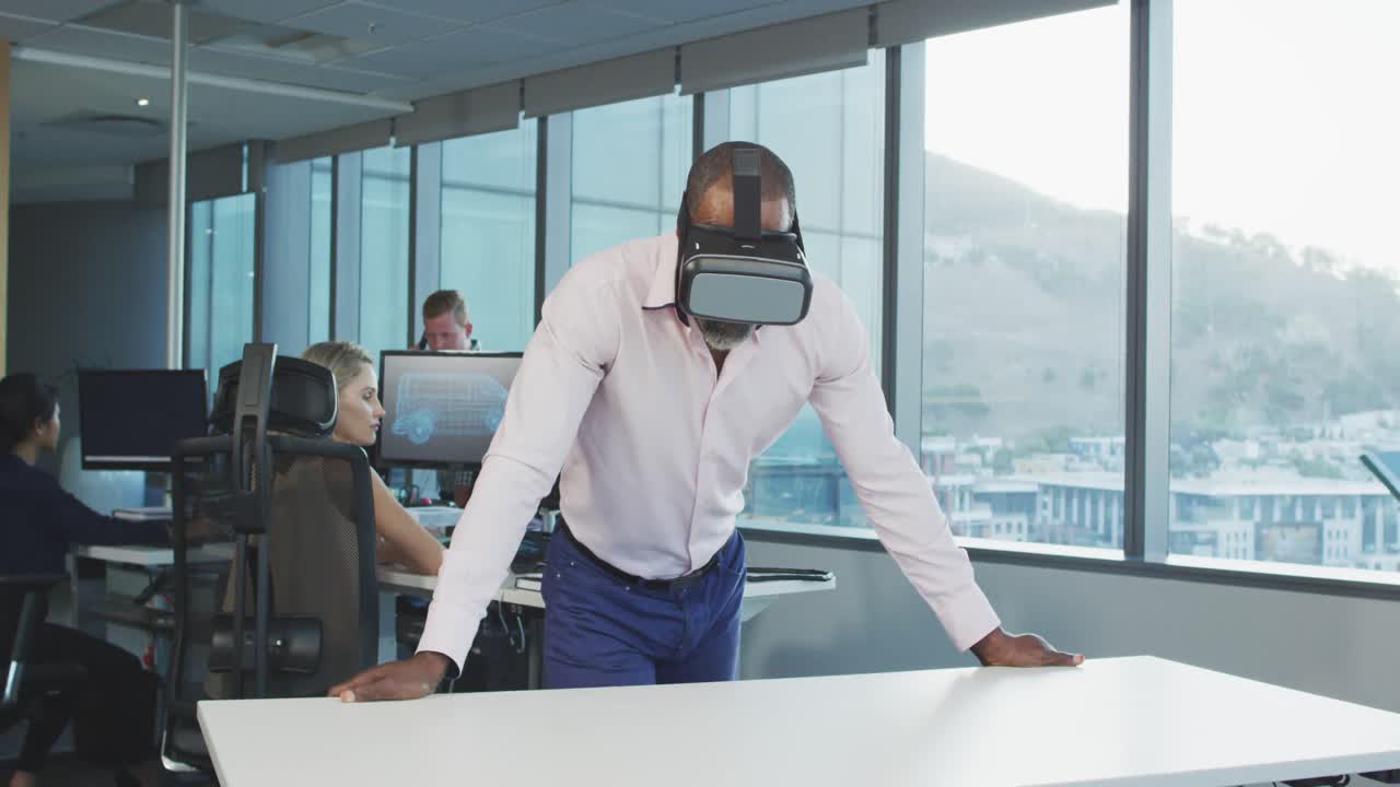 African American businessman wearing VR headset in modern office