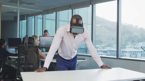 african american businessman wearing vr headset in modern office