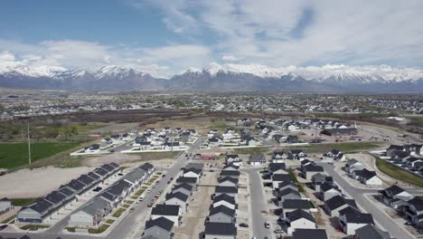 Aerial-view-of-Lehi-city-neighborhood-area-with-snowy-mountain-background,-Utah