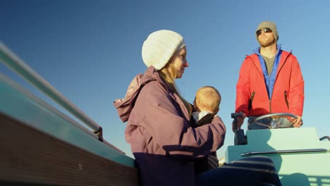 Parents-with-baby-travelling-in-motorboat-4k