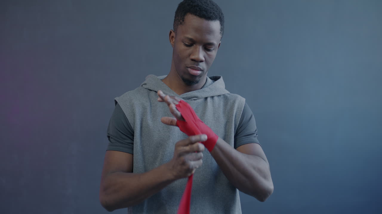 Man wrapping boxing hand wraps