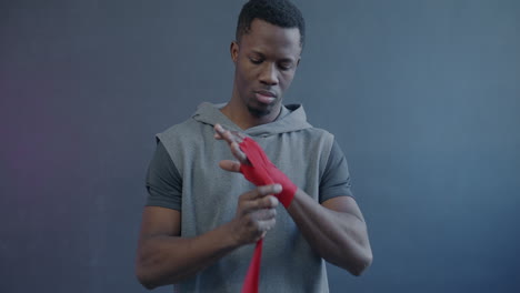 man wrapping boxing hand wraps