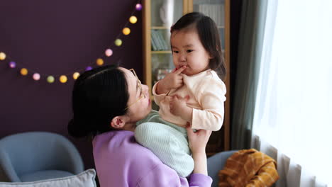 Asian-mother-holding-her-baby